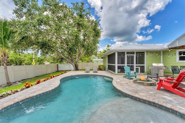 7727 9th Avenue Dr NW, Bradenton, FL 34209 - view of pool featuring a sunroom, a patio, a fenced backyard, grilling area, and an outdoor fire pit