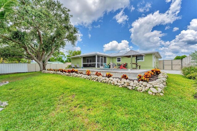 7727 9th Avenue Dr NW, Bradenton, FL 34209 - back of property featuring a sunroom and a patio