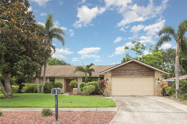 7401 3rd Ave NW, Bradenton, FL 34209 - single story home featuring stone siding, driveway, an attached garage, and a front yard