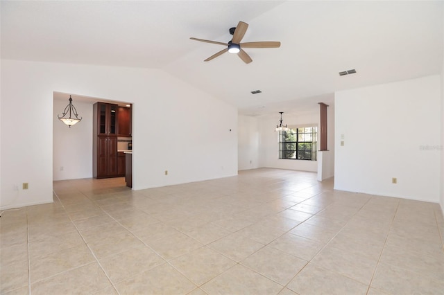 7401 3rd Ave NW, Bradenton, FL 34209 - spare room with lofted ceiling, a ceiling fan, light tile patterned flooring, and a chandelier