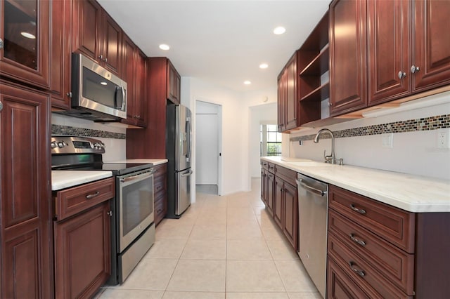 7401 3rd Ave NW, Bradenton, FL 34209 - kitchen with appliances with stainless steel finishes, open shelves, decorative backsplash, light countertops, and recessed lighting