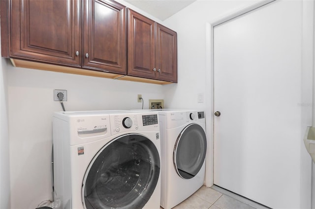7401 3rd Ave NW, Bradenton, FL 34209 - washroom with cabinet space, independent washer and dryer, and light tile patterned flooring
