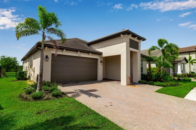 4869 Antrim Dr, Sarasota, FL 34240 - view of front facade with a garage, a tiled roof, stucco siding, and decorative driveway