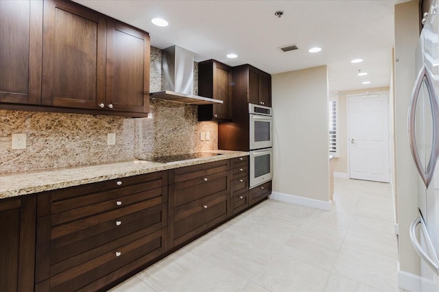 1255 N Gulfstream Ave Unit 1104, Sarasota, FL 34236 - kitchen featuring wall chimney range hood, stainless steel appliances, decorative backsplash, dark brown cabinetry, and baseboards