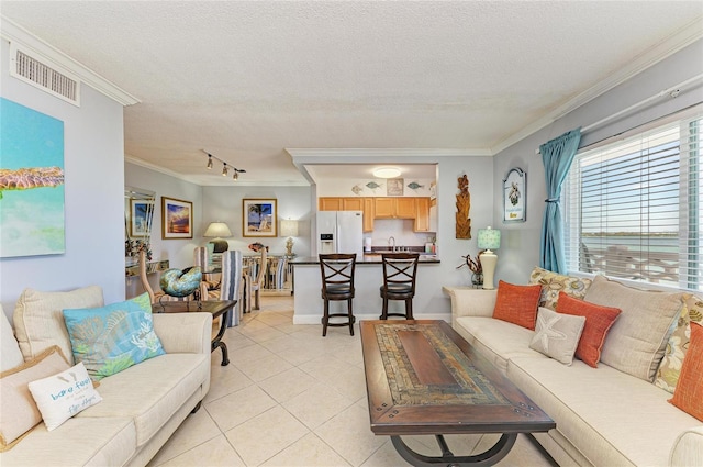 767 John Ringling Blvd Unit 25, Sarasota, FL 34236 - living area with crown molding, light tile patterned floors, a textured ceiling, and track lighting