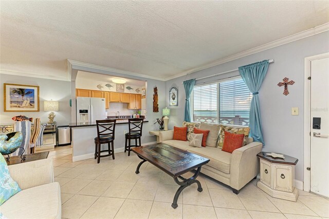 767 John Ringling Blvd Unit 25, Sarasota, FL 34236 - living area featuring ornamental molding, light tile patterned floors, a textured ceiling, and baseboards