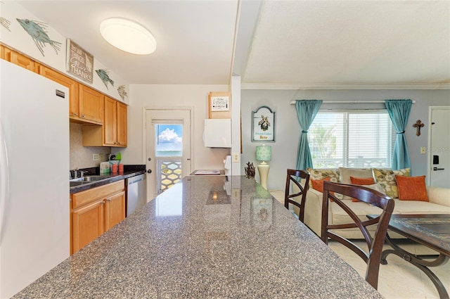 767 John Ringling Blvd Unit 25, Sarasota, FL 34236 - kitchen featuring freestanding refrigerator, dishwasher, healthy amount of natural light, crown molding, and a sink