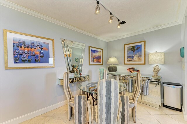 767 John Ringling Blvd Unit 25, Sarasota, FL 34236 - dining space with tile patterned flooring, ornamental molding, baseboards, a textured ceiling, and track lighting