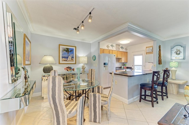 767 John Ringling Blvd Unit 25, Sarasota, FL 34236 - dining space featuring light tile patterned floors, ornamental molding, and baseboards