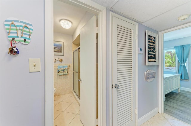 767 John Ringling Blvd Unit 25, Sarasota, FL 34236 - hallway with light tile patterned floors and baseboards