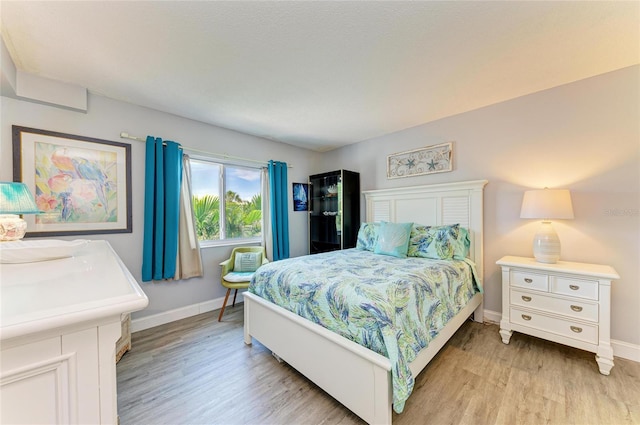 767 John Ringling Blvd Unit 25, Sarasota, FL 34236 - bedroom with light wood finished floors and baseboards