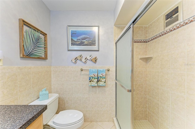 767 John Ringling Blvd Unit 25, Sarasota, FL 34236 - bathroom featuring tile walls, toilet, a shower stall, vanity, and wainscoting