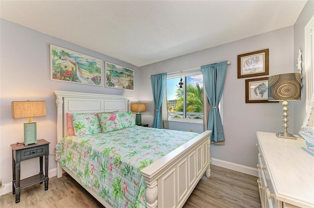 767 John Ringling Blvd Unit 25, Sarasota, FL 34236 - bedroom featuring baseboards and light wood-style floors