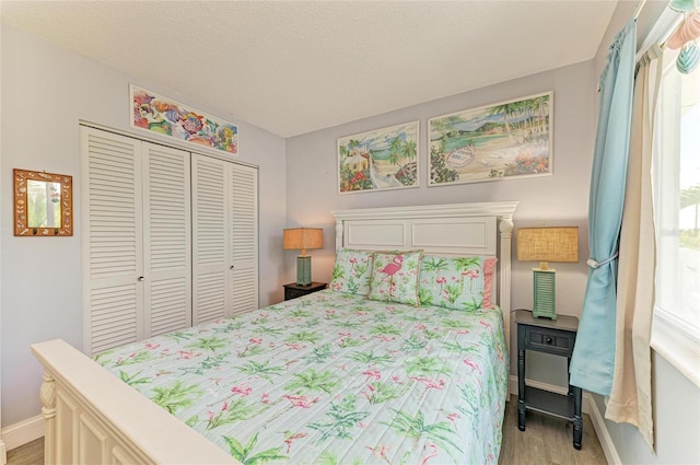 767 John Ringling Blvd Unit 25, Sarasota, FL 34236 - bedroom with a closet, light wood-style floors, and baseboards