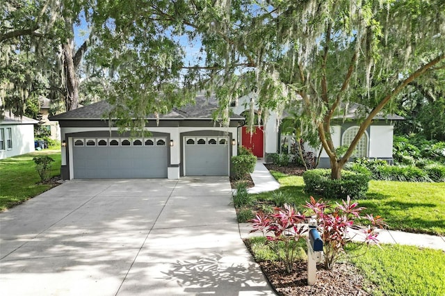5103 Twin Creeks Dr, Valrico, FL 33596 - view of front facade with driveway, stucco siding, a shingled roof, an attached garage, and a front lawn