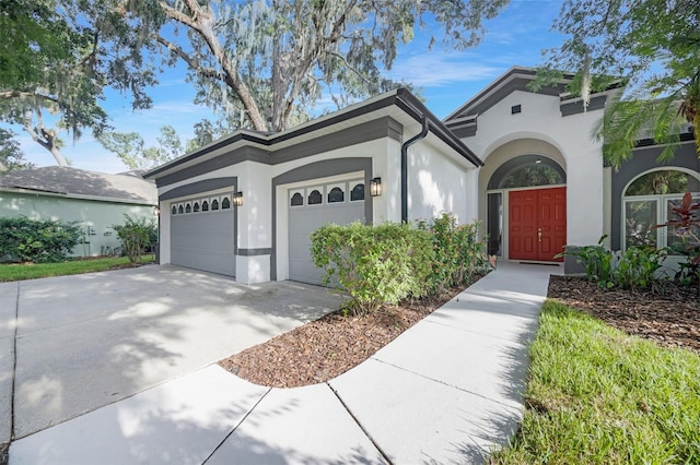5103 Twin Creeks Dr, Valrico, FL 33596 - ranch-style house with stucco siding, an attached garage, and concrete driveway