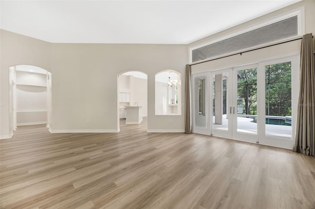 5103 Twin Creeks Dr, Valrico, FL 33596 - unfurnished room with a chandelier, light wood finished floors, and arched walkways