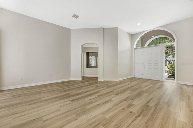 5103 Twin Creeks Dr, Valrico, FL 33596 - entryway with arched walkways, light wood-style flooring, and recessed lighting