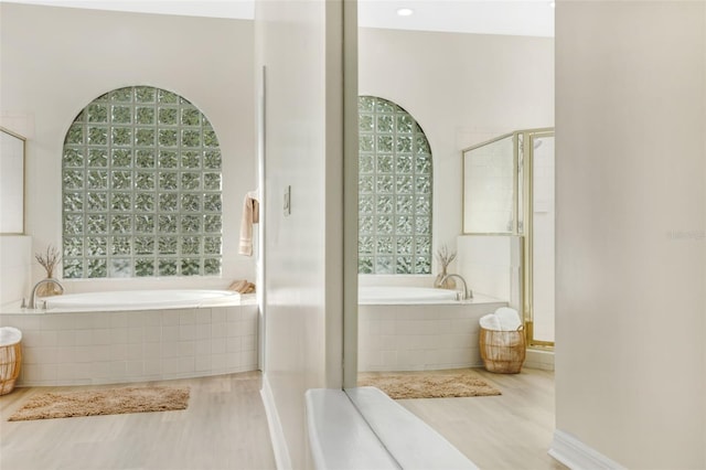 5103 Twin Creeks Dr, Valrico, FL 33596 - bathroom with a garden tub, a shower stall, and wood finished floors