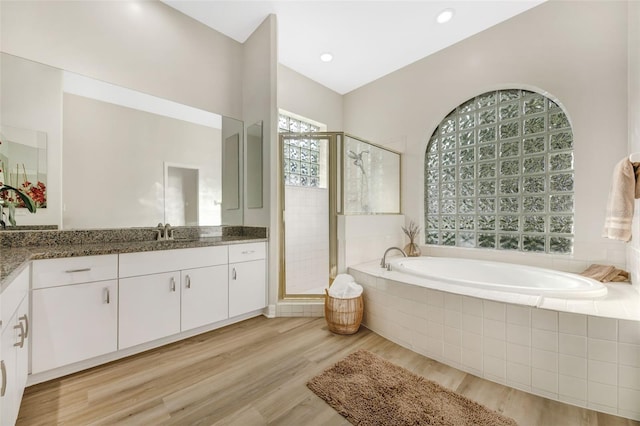 5103 Twin Creeks Dr, Valrico, FL 33596 - full bathroom featuring vanity, a garden tub, a stall shower, wood finished floors, and recessed lighting