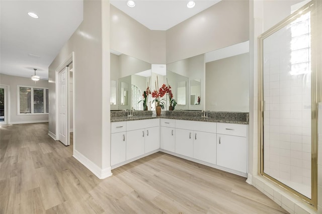 5103 Twin Creeks Dr, Valrico, FL 33596 - full bathroom featuring wood finished floors, double vanity, a ceiling fan, tiled shower, and recessed lighting