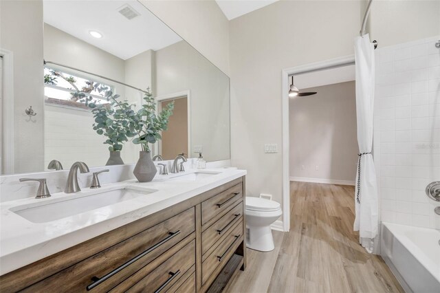 5103 Twin Creeks Dr, Valrico, FL 33596 - full bath with wood finished floors, double vanity, and shower / bath combination with curtain