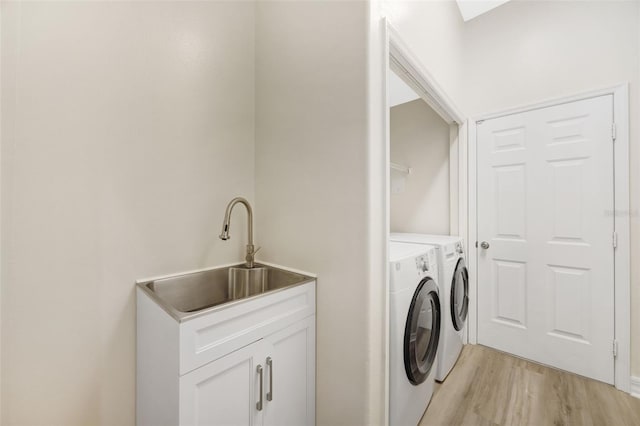 5103 Twin Creeks Dr, Valrico, FL 33596 - laundry room with washer and dryer and light wood-type flooring