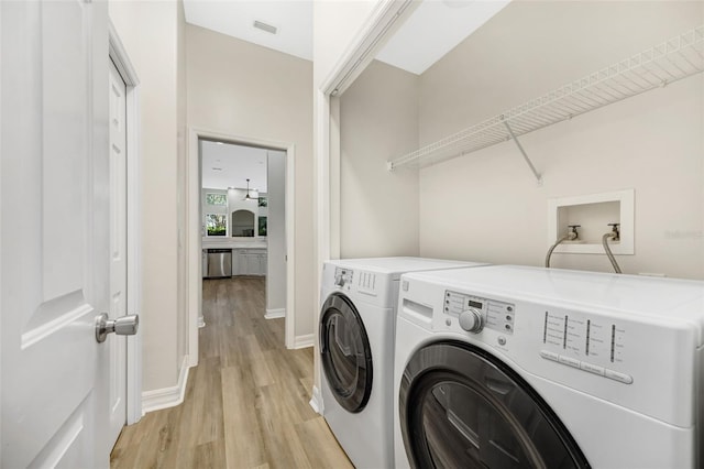 5103 Twin Creeks Dr, Valrico, FL 33596 - washroom featuring light wood-type flooring and washer and dryer