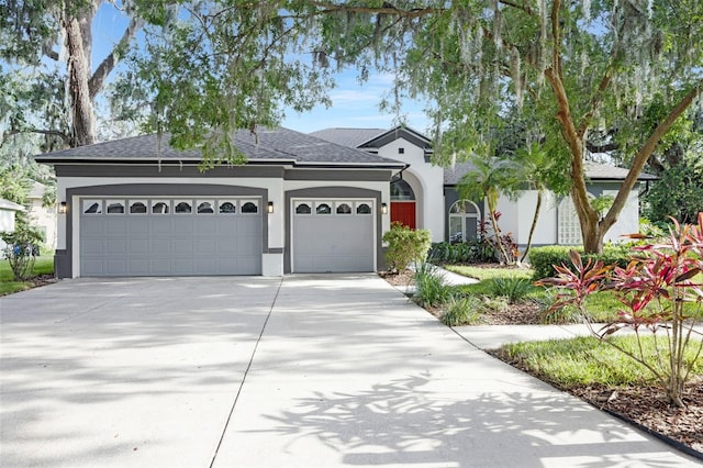5103 Twin Creeks Dr, Valrico, FL 33596 - view of front of property with stucco siding, a garage, driveway, and roof with shingles