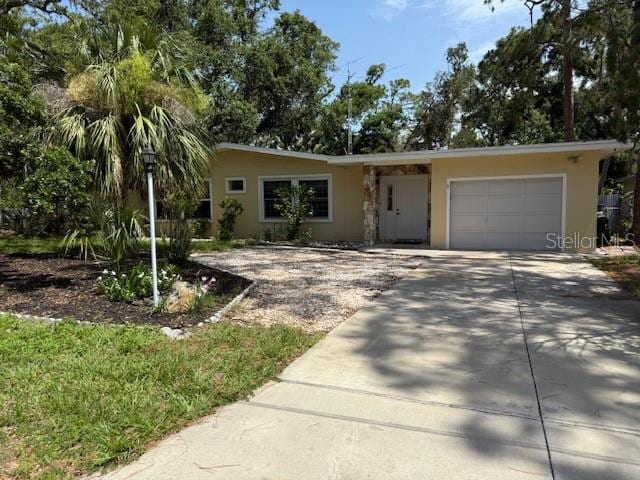 2311 W 52nd Ave Drive, Bradenton, FL 34207 - view of front of home featuring an attached garage, driveway, and stucco siding