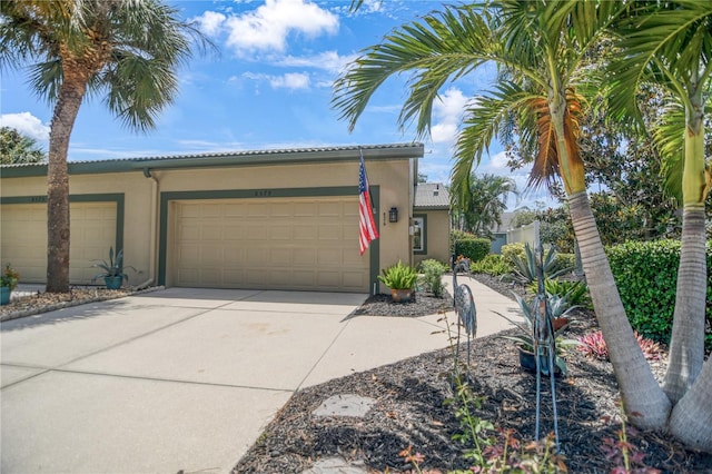 8579 54th Avenue Cir E, Bradenton, FL 34211 - view of front of property featuring driveway, stucco siding, and a garage