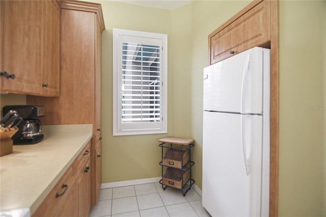 8579 54th Avenue Cir E, Bradenton, FL 34211 - kitchen with freestanding refrigerator, light countertops, and light tile patterned floors