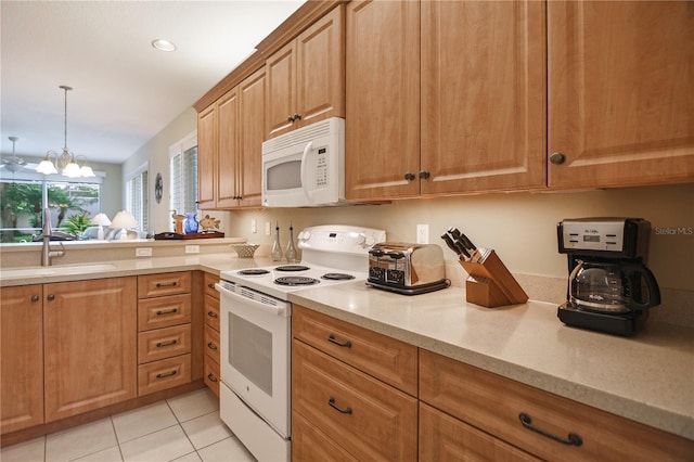 8579 54th Avenue Cir E, Bradenton, FL 34211 - kitchen featuring white appliances, light tile patterned floors, a chandelier, light stone countertops, and recessed lighting