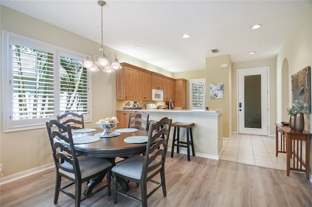 8579 54th Avenue Cir E, Bradenton, FL 34211 - dining area featuring plenty of natural light, a chandelier, light wood-type flooring, and recessed lighting
