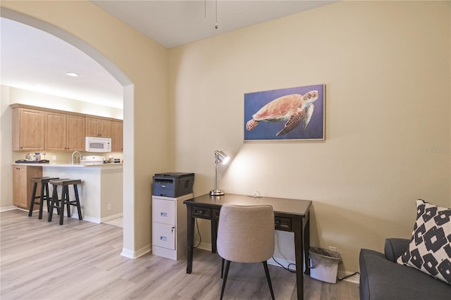 8579 54th Avenue Cir E, Bradenton, FL 34211 - office area with arched walkways and light wood-style flooring