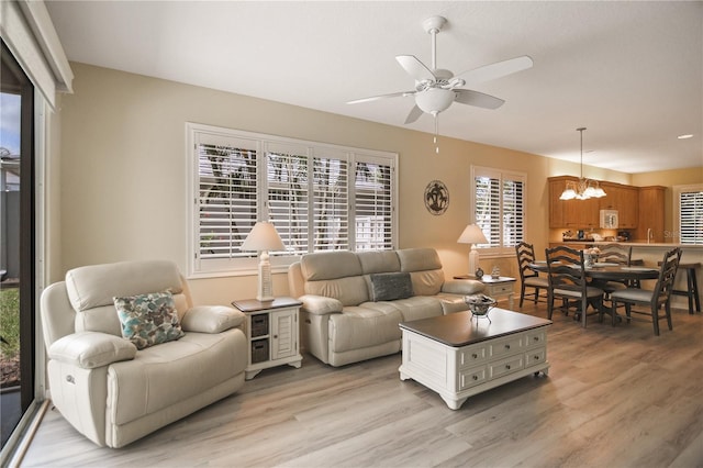 8579 54th Avenue Cir E, Bradenton, FL 34211 - living area with a chandelier, a ceiling fan, and light wood finished floors