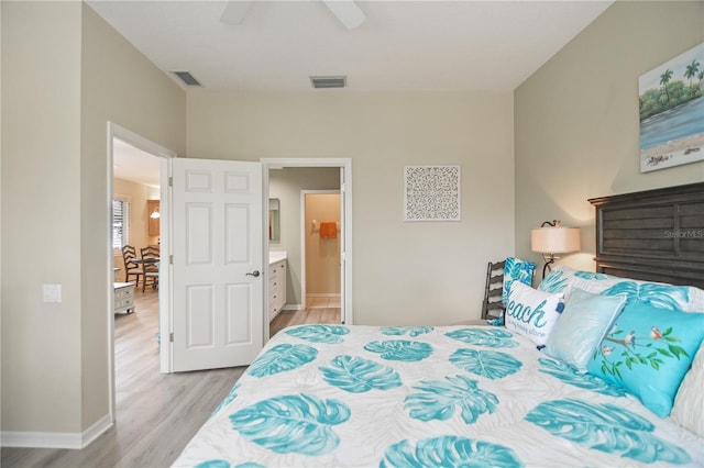 8579 54th Avenue Cir E, Bradenton, FL 34211 - bedroom featuring light wood-type flooring, ceiling fan, and ensuite bath
