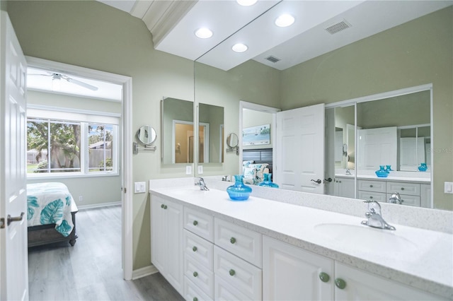 8579 54th Avenue Cir E, Bradenton, FL 34211 - ensuite bathroom with double vanity, wood finished floors, a ceiling fan, and recessed lighting