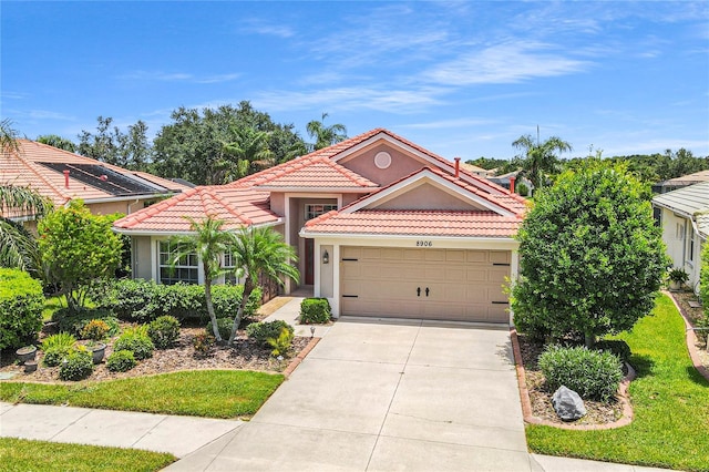 8906 Stone Harbour Loop, Bradenton, FL 34212 - mediterranean / spanish-style house featuring a tile roof, stucco siding, driveway, and an attached garage