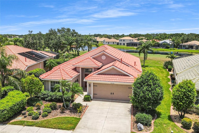 8906 Stone Harbour Loop, Bradenton, FL 34212 - view of front facade featuring a tiled roof, concrete driveway, a residential view, and a garage