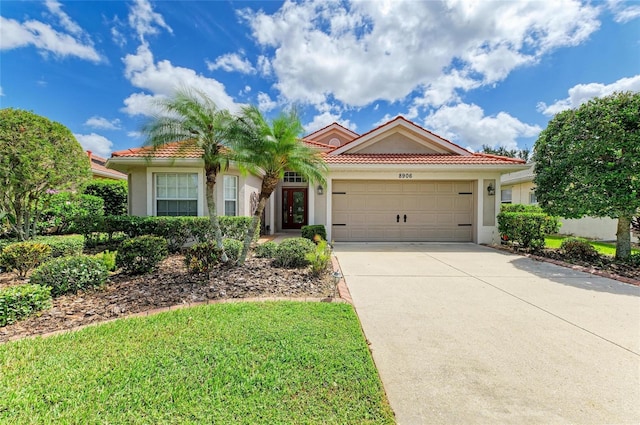 8906 Stone Harbour Loop, Bradenton, FL 34212 - view of front of house with stucco siding, a garage, and a tiled roof