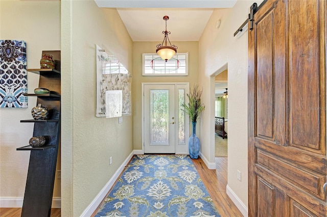 8906 Stone Harbour Loop, Bradenton, FL 34212 - foyer entrance with a barn door and light wood-style flooring