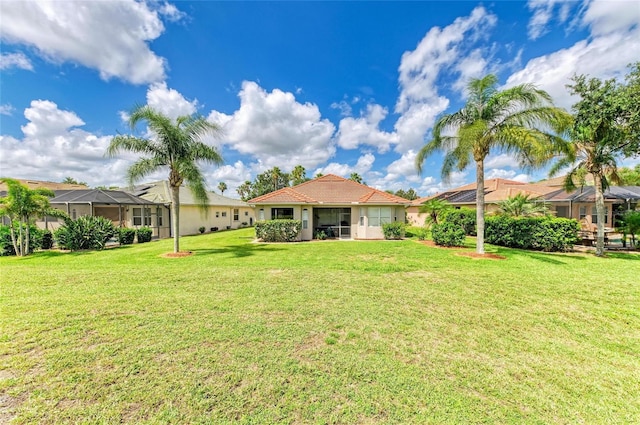 8906 Stone Harbour Loop, Bradenton, FL 34212 - rear view of property featuring a lawn, stucco siding, and a tile roof
