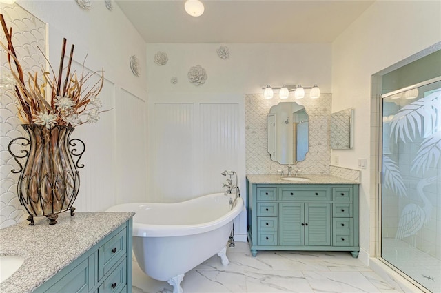 8906 Stone Harbour Loop, Bradenton, FL 34212 - bathroom featuring two vanities, a shower stall, a freestanding bath, marble finish flooring, and wainscoting
