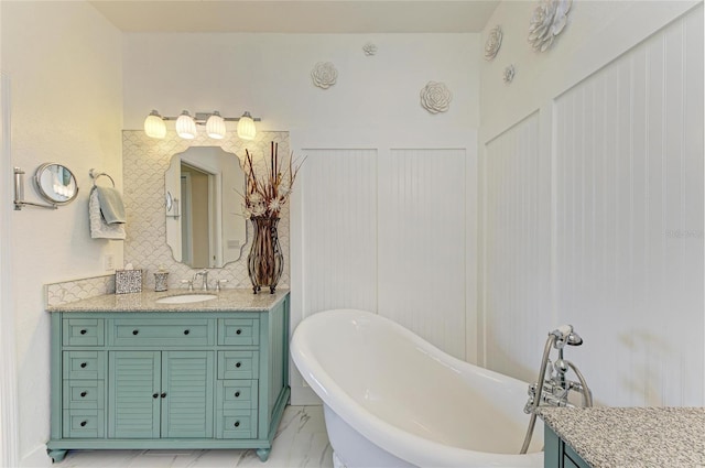8906 Stone Harbour Loop, Bradenton, FL 34212 - full bathroom with vanity, a freestanding bath, marble look tile flooring, and a decorative wall
