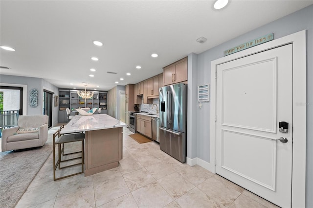 5806 Gulf Dr Unit 201S, Holmes Beach, FL 34217 - kitchen featuring stainless steel appliances, recessed lighting, a chandelier, light stone counters, and open floor plan