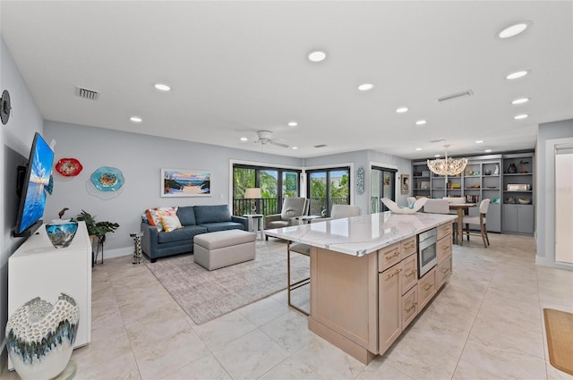 5806 Gulf Dr Unit 201S, Holmes Beach, FL 34217 - kitchen featuring recessed lighting, stainless steel microwave, a breakfast bar, a center island, and a chandelier