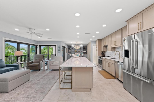 5806 Gulf Dr Unit 201S, Holmes Beach, FL 34217 - kitchen with appliances with stainless steel finishes, open floor plan, recessed lighting, a center island, and a breakfast bar