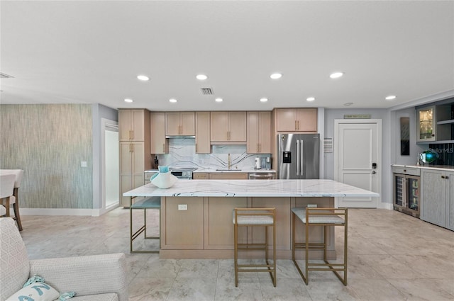 5806 Gulf Dr Unit 201S, Holmes Beach, FL 34217 - kitchen with stainless steel appliances, a breakfast bar area, light stone countertops, recessed lighting, and a large island