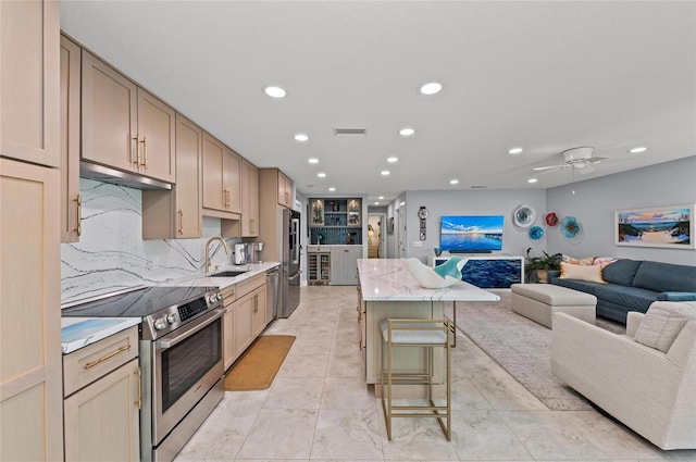 5806 Gulf Dr Unit 201S, Holmes Beach, FL 34217 - kitchen featuring stainless steel appliances, recessed lighting, open floor plan, a kitchen breakfast bar, and under cabinet range hood